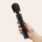 Hand holding a black magic wand massager